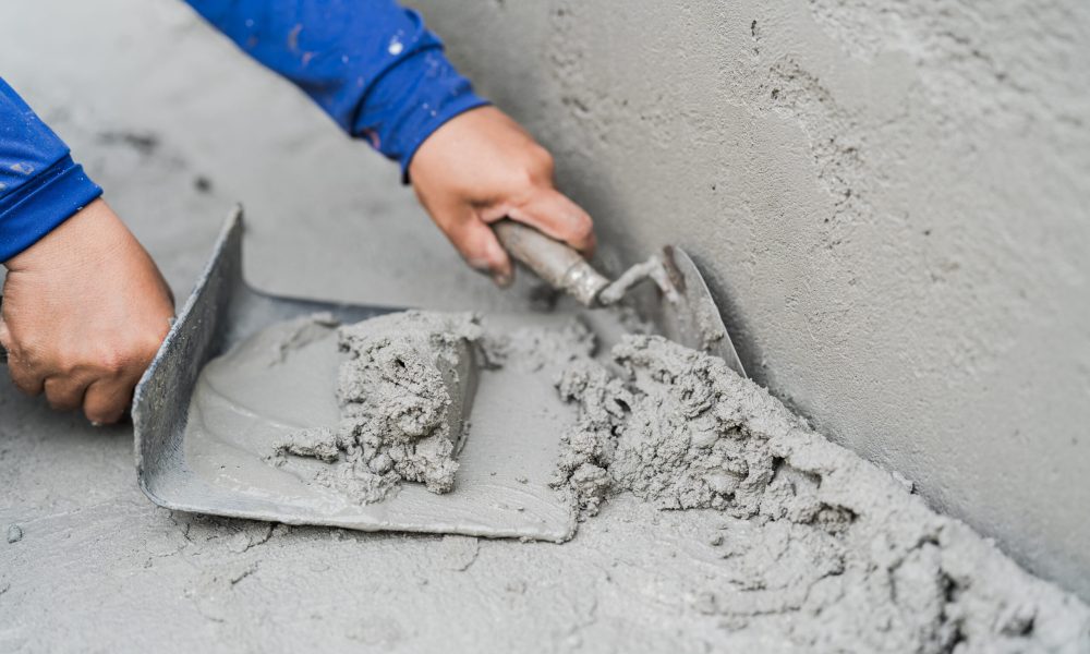 hand-worker-plaster-cement-concrete-with-trowel-to-2023-09-21-20-17-49-utc